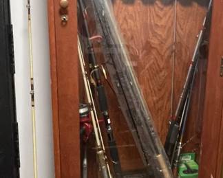 Fishing poles and gun/fishing cabinet.