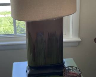 Pair of ceramic table lamps and green end tables.