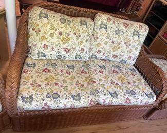 Four-piece rattan set - sofa, love seat, chair and ottoman.