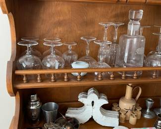 Hutch with assorted glassware and barware.