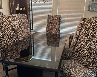 This is a beautiful lacquer table with leopard chairs 