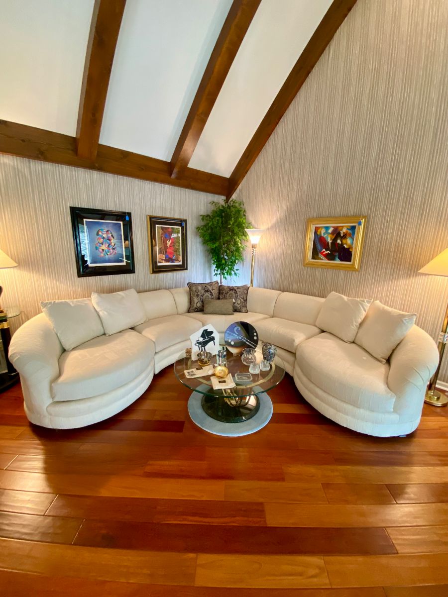 Drexel contemporary curved sofa, Art “Ingredients” by  Linda Le Kinff (French, Born 1949“, Instruments Imitating Life” by Marcus Glenn“Ingredients”,  Anatole Krasnyansky , "Play That Horn II" Matted Framed Art .  
Brass and glass round coffee table, Michael Aram, Kosta Boda