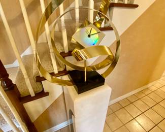 Pedestal and modern gold tone metal free form decorative clock