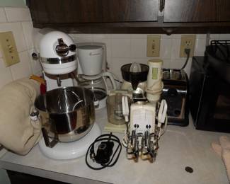 KitchenAid stand mixer with attachments and cover. Lots of small kitchen appliances 