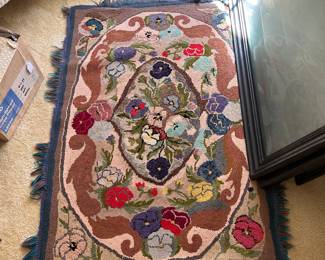 One of several hand-hooked rugs