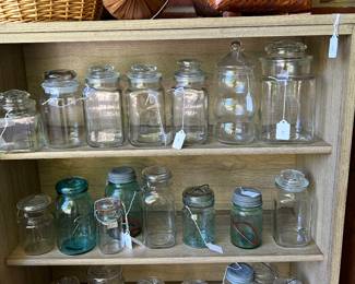 Many vintage canning jars and apothecary jars