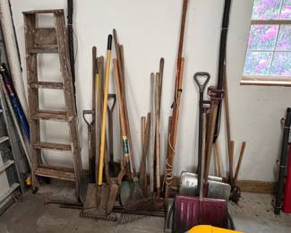 Group of yard tools including painting poles, wooden ladder, shovels and rakes, wear to all (LL)