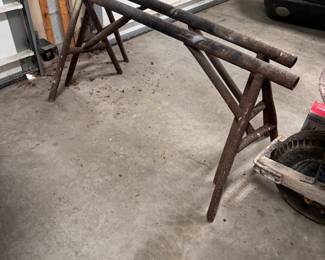 Custom-built iron saw horses, some oxidation, and some holes, appear sturdy 24"H x 48"L