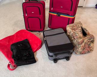 Assortment of suitcases, the largest is 25"H