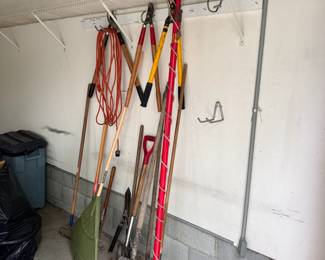 Group of yard tools with trimmers, pole trimmer, rakes (UL)