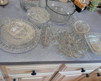 Group of clear glass bowls, platters, dishes, pumpkin
