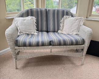 Woven vinyl patio loveseat with blue striped cushions 52"W x 30"D