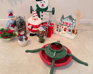 Group of Christmas decorations including snowman towel holder, tree stand, and Santa cookie jar