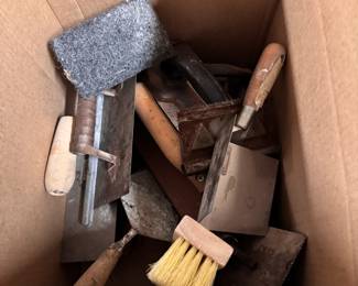 Box of mostly concrete trowels and tools