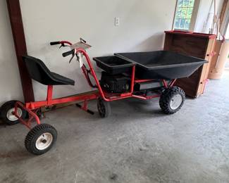 Self-propelled wheelbarrow with accessories, seat, wooden wagon insert, not fully tested, pulls easily, has automatic start, and may need battery charge or replacement
