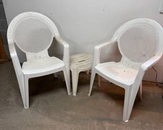 White plastic patio chairs and small table