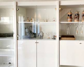 This stunning 3 piece unit can be easily separated. Includes bar with built-in holders for precious stemware. The middle unit houses a television or stereo. Off white lacquer with glass doors.