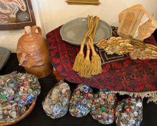 Bottle caps, face jug, small antique rug, Egyptian artifact