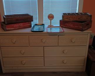 Cream color dresser, coca cola crates and trays