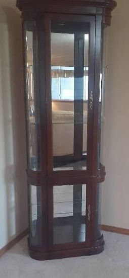 Display cabinet. Lights up. Has 4 glass shelves. 76 x 26 x 12. Located in basement