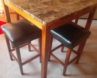 Greenworld Furniture Co. table with 4 stools. 36 x 36 x 36. Top looks like granite. Located in basement