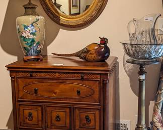 One each of a pair of phenomenal yew wood bachelor chests, butter yellow cloisonne table lamps, oval gilt wood (not resin!) wall mirrors and a hand-carved/painted wooden pheasant by Bog Sky Carvers.