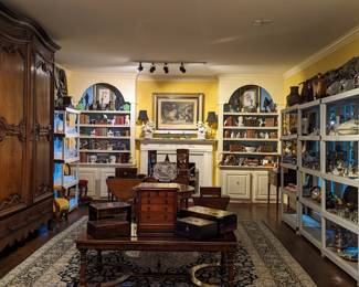 Living room filled with amazing antiques, smalls, table lamps, books, pair of Victorian chairs, antique French oak armoire, English boxes, tables, an antique desk, artwork and more!