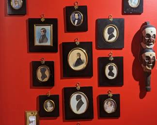 Nice collection of framed silhouettes, riding crops and wooden puppet. 