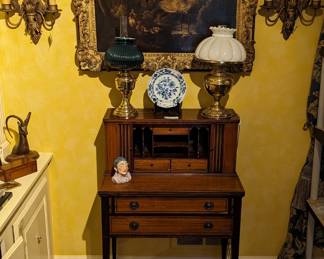 Antique English inlaid mahogany writing desk, with tambour doors, brass oil lamps (one electrified), pair of two-light wall sconces and antique, beautifully framed original oil on canvas.