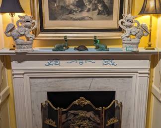 Lemon gilt wood frame on the antique lithograph of "The First Lesson" by American Artist Nathaniel Currier, vintage English brass fire screen, pair of vintage blanc de chine glazed ceramic foo dogs, measuring 16" tall, pair of Baldwin brass candlestick lamps, pair of nicely patinaed elephant candlesticks and brass trivets.