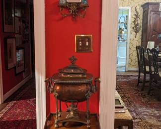 One of a pair of brass/enameled wall sconces, with two candleholders and beveled glass, antique English wooden smoking stand with vintage copper and brass samovar. 
