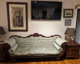 Pair of hand-carved wooden side tables, with two doors and single drawer, pair of gold metal lamps, Victorian couch and vintage framed artwork. 