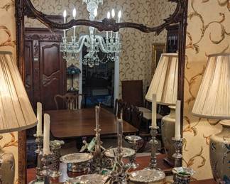 Segmented wooden wall mirror, with sterling and silver plated silver displayed.