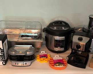 Steam tray, Instant Pot 8 qt 10-in1 cooker (new in box), Breville juicer (unboxed, but never used), DeLonghi cappuccino/espresso maker EC155 (with box), Instant Pot accessories, Hamilton Beach double breakfast sandwich maker.