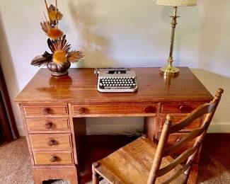 Lot 028-BR2: MC Student Desk Vignette

Features: 
•	Small mid-century wooden desk, typewriter, brass table lamp, ladderback chair and mid-century décor included
•	Typewriter is a vintage Smith Corona
•	Desk drawers are lined with cedar wood.

Dimensions: 
•	Desk: 49.5”W x 23.5”D x 29.5”H
•	Chair: 18”W x 16.5”D (seat) x 38.5”
•	Lamp: 26”H


Condition: Good pre-owned condition. Surface finishes on desk and chair exhibit some age-and-use-related wear.
