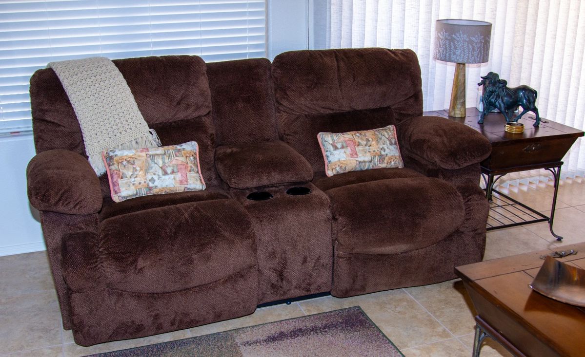 Beautiful upholstered reclining loveseat with cupholders and center storage