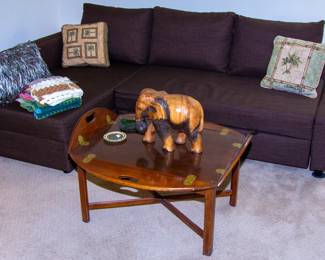 Upholstered sectional and small wooden coffee table