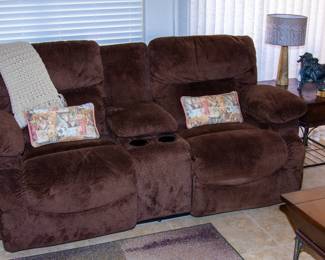 Beautiful upholstered reclining loveseat with cupholders and center storage