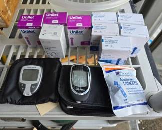#10578 • (2) Blood Glucose Meters, (2) Cases, and Lancets
