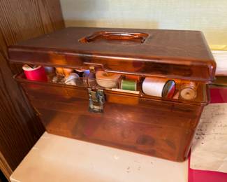 vintage amber sewing box with thread & misc.