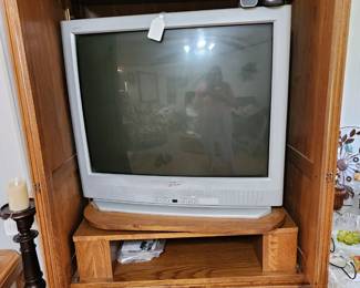 Zenith television in a pretty oak cabinet that closes to hide the television