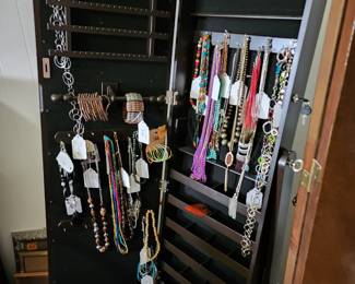 Stand alone jewelry cabinet with large mirror on the front