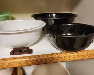 The 2 black bowls and white bowl are actually nesting bowls with the fired on color