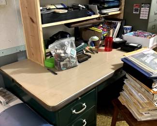 Office desk with loads of supplies.