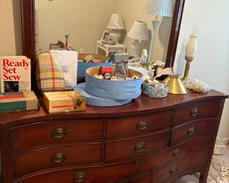 Sewing books, thread and other sewing accessories. Beautiful dresser and vintage lamp in working condition