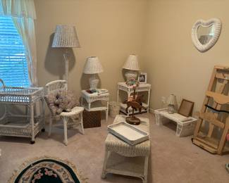 Several pieces of white wicker furniture, working lamps, area rug, quilter