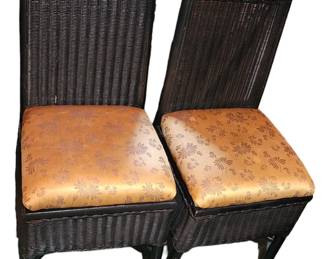 Two wicker chairs with fabric covered cushions