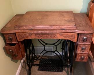 Complete antique treadle sewing machine in beautiful oak cabinet