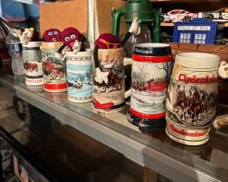 Just a few of the very large collection of Steins in this Estate. Featured here are some of the Budweiser Steins  the "We Heard It On the Grapevine" Grapes!