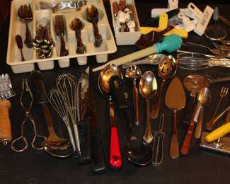 Assorted kitchen gadgets and utensils. Stainless silverware set as well. 